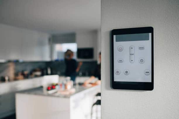 Commande tactile fixée au mur pour régler le thermostat de la pièce